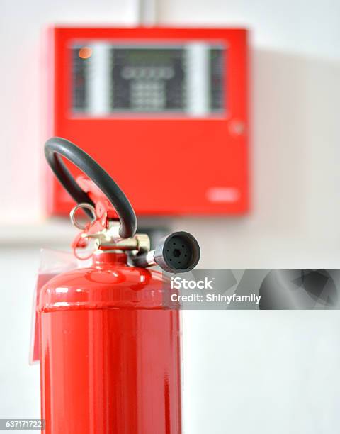 Fire Extinguisher and blurred Fire Alarm box in background. Safety first!